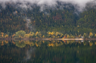 Fall colours reflecting on lake.